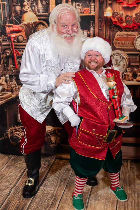 Santa Doug laughing with one of his elves in the toy workshop