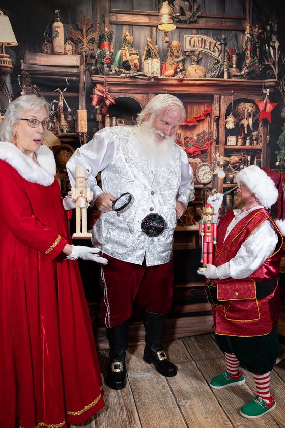 Mrs. Claus, Santa Doug and an elf with nutcrackers in the toy workshop